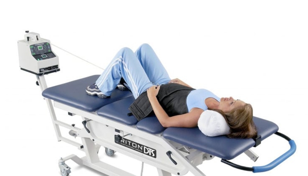 Patient undergoing non-surgical spinal decompression therapy on a computerized table
