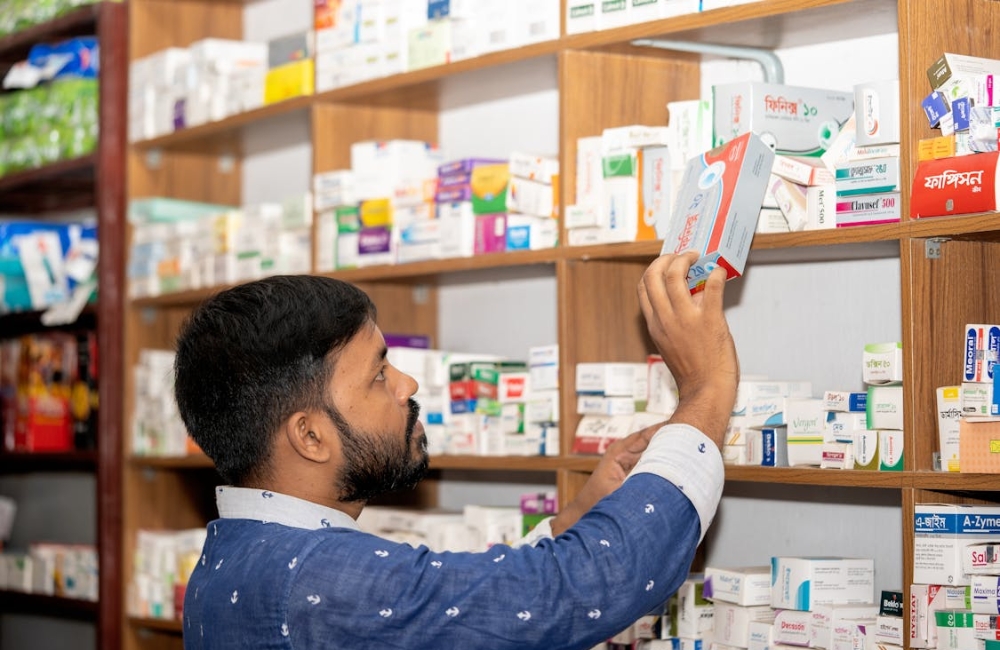 Bright and organized hospital pharmacy shelves systematically packed with diverse medication boxes